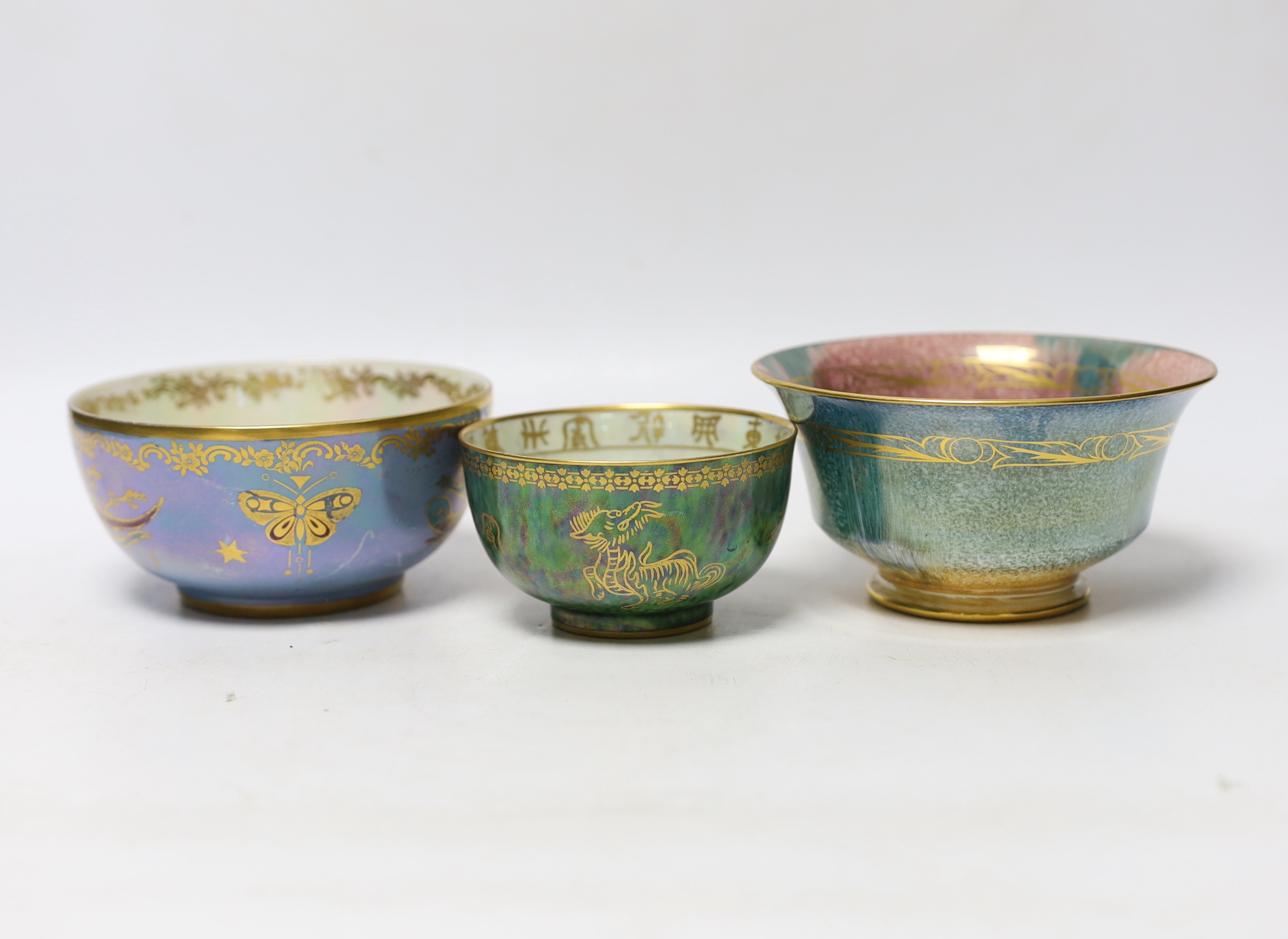 A small Wedgwood dragon lustre footed bowl, with Chinese characters and dragon to centre, together with a Minton’s pedestal lustre bowl and a further Crown Devon example, tallest 6cm (3)